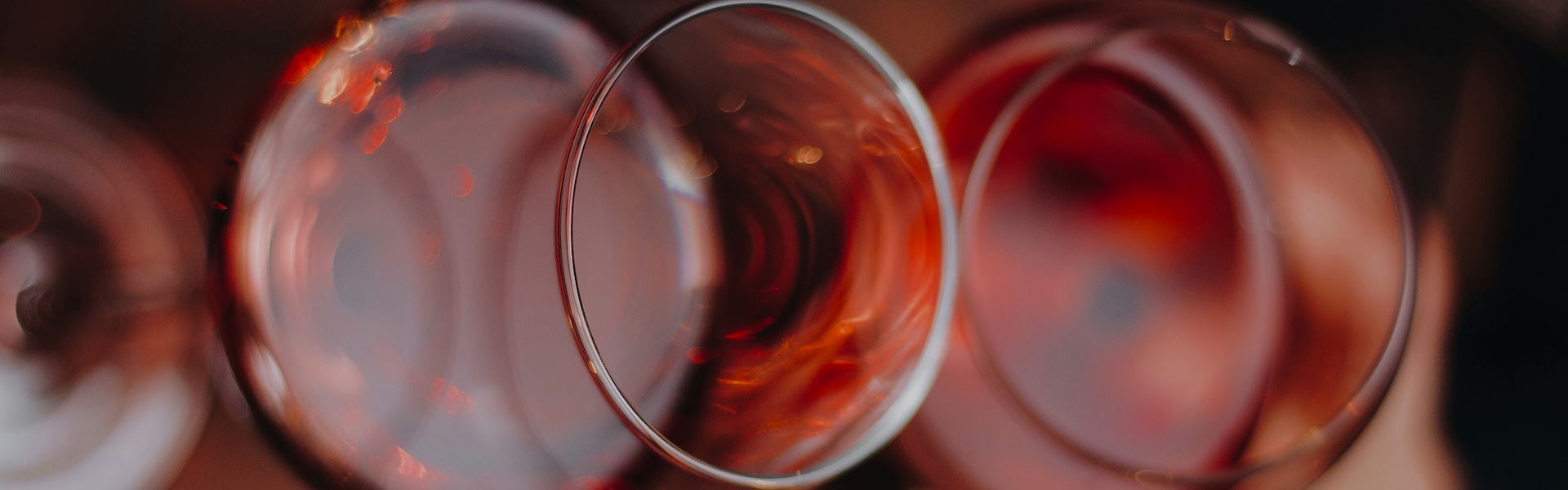 Two wine glasses clinking together in a celebratory toast.