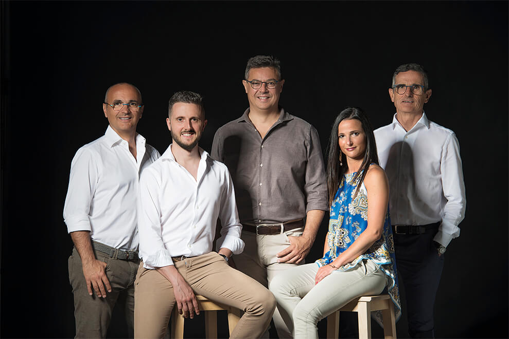 The Tombacco family, owners of Tenuta San Giorgio, posing together in front of their historic winery.